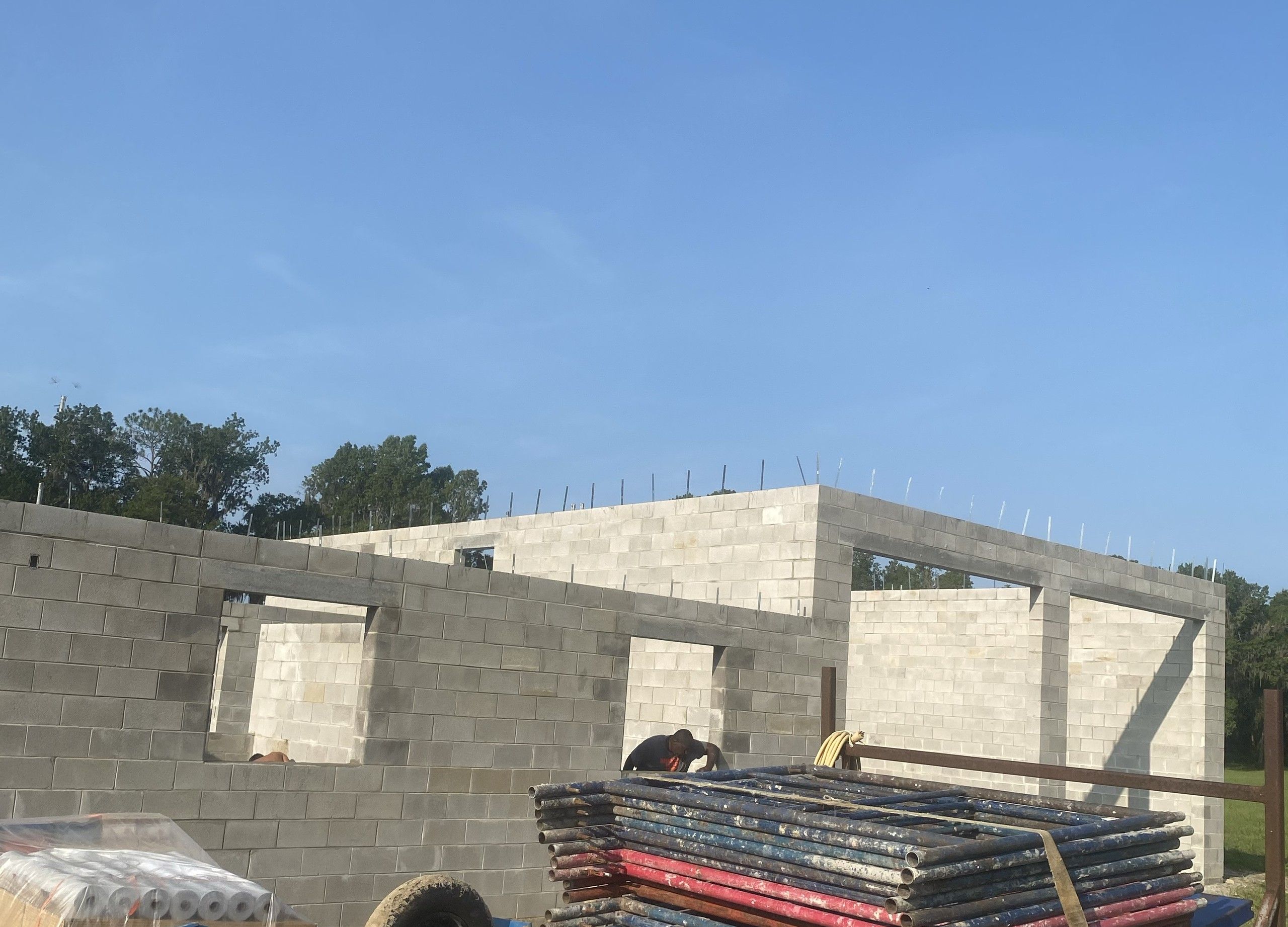 Reinforced block walls of a large single-storey building under a clear sky