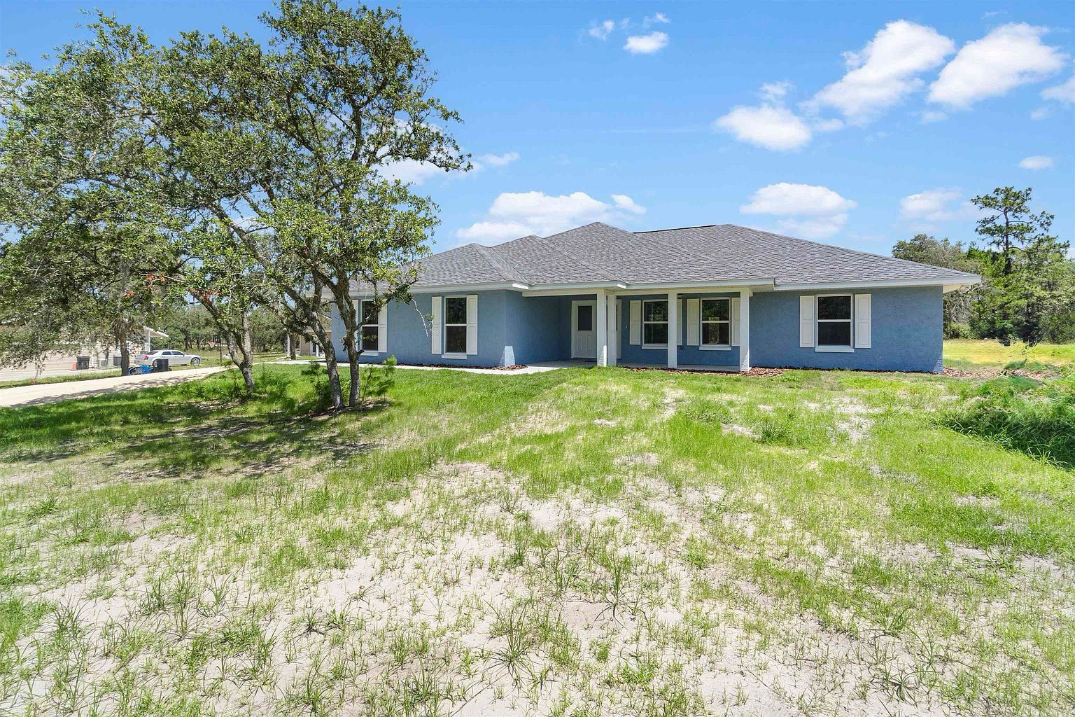 Completed Benchmark Construction home on a broad grass lot near Gainesville