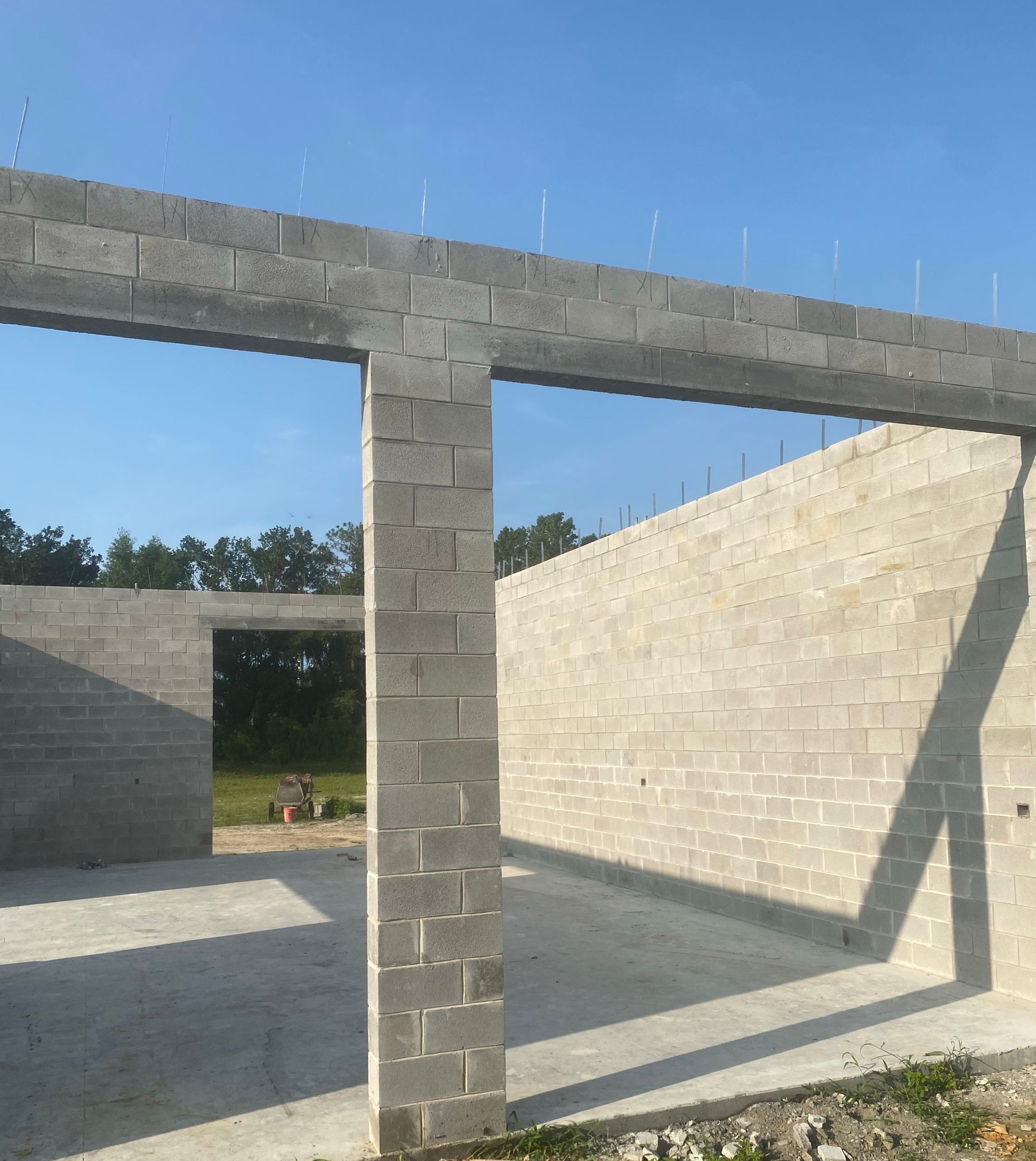 Concrete block walls and lintels rising on a Benchmark Construction job site